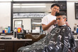 © Jordana Sheara/Stocksy - Latin teenager getting a haircut in a barbershop