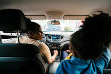 Calm Black Family Travelling Together In Car