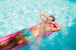© Ibai Acevedo/Stocksy - Relaxed man floating in pool with water splash