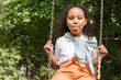 © Danil Nevsky/Stocksy - Cute naughty girl on swing set