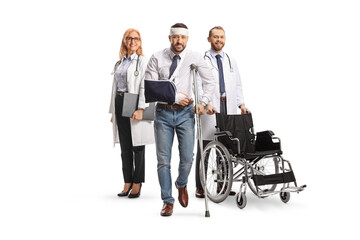 Canvas Print - Man with an injured head and arm standing with a male and female doctors