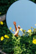 © Berena Alvarez/Stocksy - Conceptual photo Of A Woman With A Mirror In the field