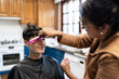 © Alvaro Lavin/Stocksy - woman cutting another woman's hair at home