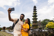 Couple Taking Selfie In Bali Using Phone