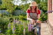 © Sveta SH/Stocksy - Woman gardener working in the flower garden.