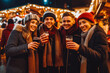 © VisualProduction - Mulled wine at christmas market with friends. Christmas market and shopping concept. Fairy lights and snow. Generative AI