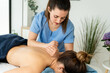 © nomad studio/Stocksy - Female physical therapist giving massage to woman.