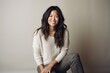 © Eber Braun - Portrait of a smiling young asian woman sitting on the floor