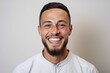 © Eber Braun - Portrait of a happy young man smiling at camera over white background