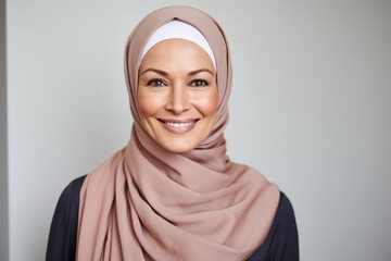 Wall Mural - Portrait of happy muslim woman in hijab looking at camera.