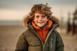 © Eber Braun - Portrait of a cute little boy in a warm jacket on the beach