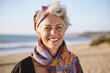 © Eber Braun - Portrait Of Mature Woman Wearing Scarf Relaxing On Beach