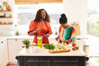 © Trinette Reed/Stocksy - Mature Black women friends making cocktails in the  kitchen