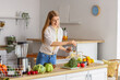 © Pixel-Shot - Young woman sprinkling salad with flax seeds in kitchen