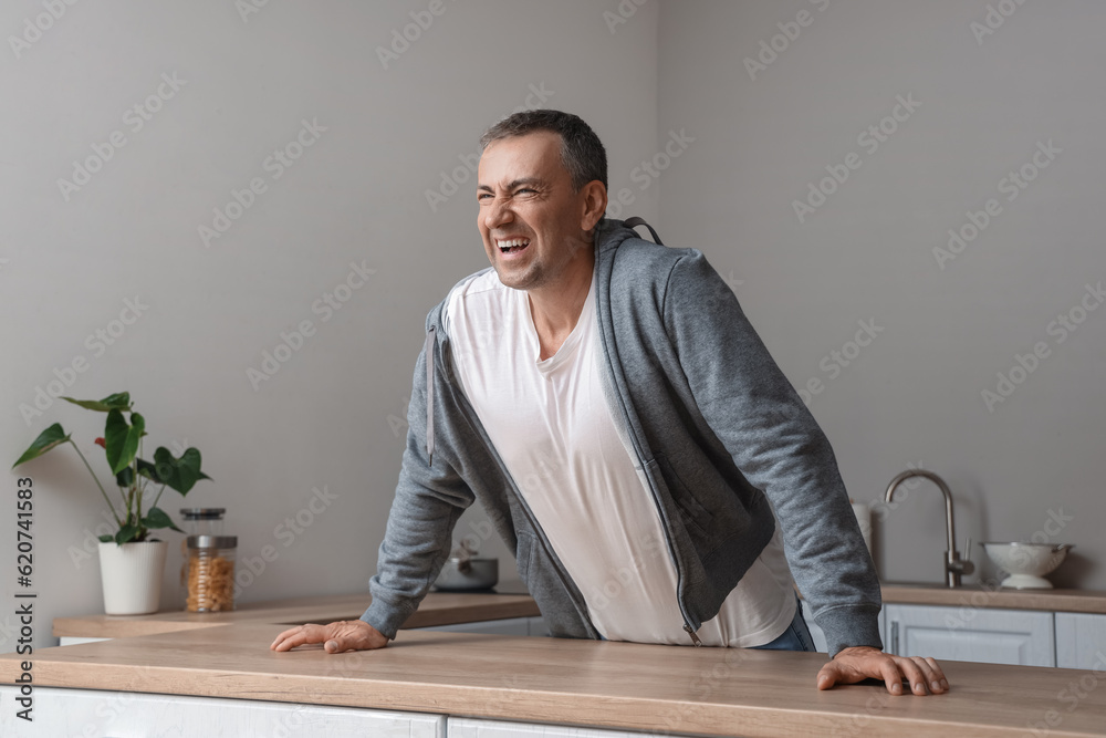 Mature man having panic attack in kitchen
