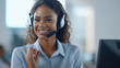© tashechka - Businesswoman in a sleek headset sits at her workstation, ready to assist customers with a friendly smile