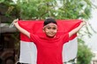 happy indonesian kids with flag at outdoor
