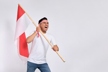 excited young asian men celebrate indonesian independence day on 17 august by holding the indonesian