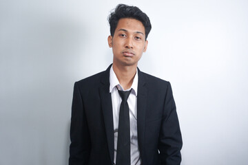 Young business man wearing suit and tie over white isolated background thinking looking tired and bored with depression problems