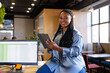 Portrait of happy plus size african american casual businesswoman using tablet in office