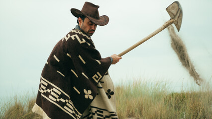 Man digs a grave in the desert