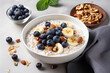 Oat porridge with banana, blueberry, walnut, chia seeds and almond milk for healthy breakfast or lunch. 