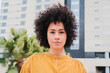 © Jose Calsina - Close up individual portrait of young adult woman looking pensive at camera standing outside. Head shot of proud hispanic female with serious expression and curly hair. Successful lady contemplating