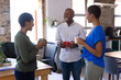 © Wavebreak Media - Happy african american colleagues talking and drinking coffee in creative office