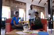© Wavebreak Media - Happy african american colleagues discussing work with coffee in creative office