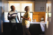 © Wavebreak Media - Senior african american couple drinking coffee and talking in kitchen
