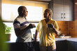 © Wavebreak Media - Senior african american couple drinking coffee and talking in kitchen
