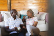 © Wavebreak Media - Senior african american couple sitting on floor and drinking coffee at home