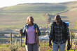 © Wavebreak Media - Happy senior african american couple with backpacks walking and talking in sunny nature
