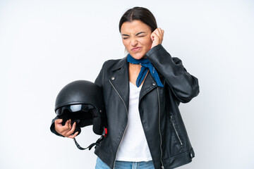 Poster - Young caucasian woman with a motorcycle helmet isolated on blue background frustrated and covering ears