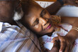 © Wavebreak Media - Senior african american couple lying on sofa and embracing at home