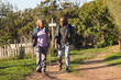 © Wavebreak Media - Happy senior african american couple with backpacks walking in sunny nature