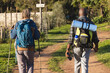 © Wavebreak Media - Senior african american couple with backpacks walking in sunny nature