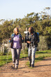 © Wavebreak Media - Senior african american couple with backpacks walking in sunny nature