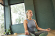 © Wavebreak Media - Caucasian woman practicing yoga on mat in studio, copy space