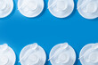 © chandlervid85 - Disposable waste plastic pattern on blue background. Top view. Copy space