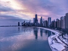 City Skyline With John Hancock Center And Frozen Lake Michigan At Sunrise, Chicago, Illinois, USA
