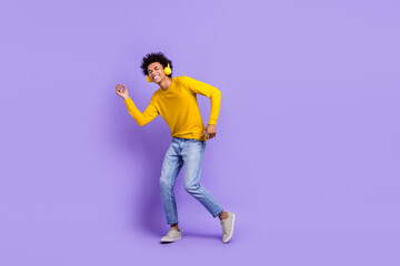 Sticker - Full size photo of good mood handsome guy dressed yellow long sleeve headphones dancing enjoy music isolated on purple color background