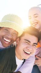 Wall Mural - Vertical selfie of Piggyback friends taking smiling selfie together outdoors in a Self portrait of a group of young people having fun together Guys and Girls looking camera posing for the photo