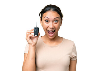 Wall Mural - Young Uruguayan woman holding car keys over isolated chroma key background with surprise and shocked facial expression