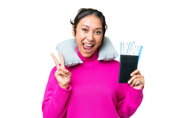 Wall Mural - Young Uruguayan woman holding a passport over isolated chroma key background smiling and showing victory sign