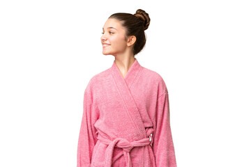 Poster - Teenager girl in a bathrobe over isolated chroma key background looking side