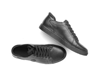 black leather sneakers on a white background