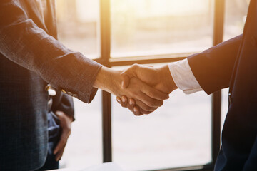 Business handshake for teamwork of business merger and acquisition,successful negotiate,hand shake,two businessman shake hand with partner to celebration partnership and business deal concept