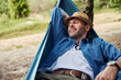© baranq - Happy adult man relaxing in hammock