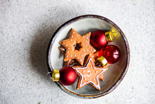 Overhead View Of A Christmas Star Shaped Cookies And Christmas Baubles In A Bowl